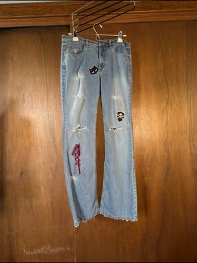 Distressed Light Blue Women’s Jeans with Patch & Lace-Up Detail